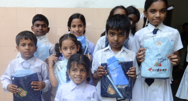 Children receiving school uniforms at Karuna Kendra Centre